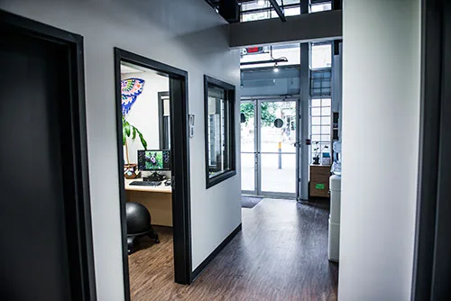 A bright hallway with private interview rooms off to the side